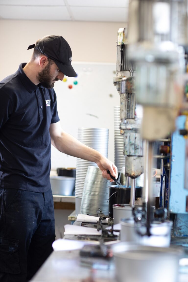 Technician mixing offset inks in a lab for precision printing solutions.