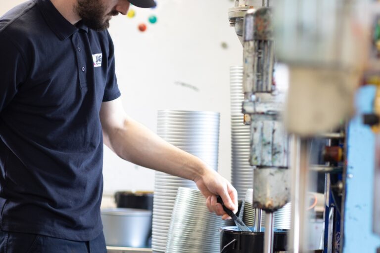 Technician mixing offset inks in a lab for precision printing solutions.